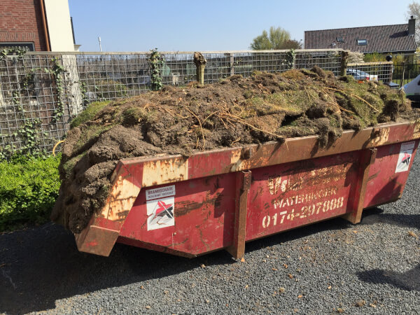 Verwijderde graszoden in de afvalcontainer