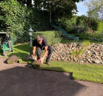 Graszoden worden door een hovenier in de trouwtuin bij De Kruimel aangelegd